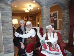 Bonnie Ross Parker gets a special hug from Santa while Mrs Claus sits ready to give her a thoughtful gift.